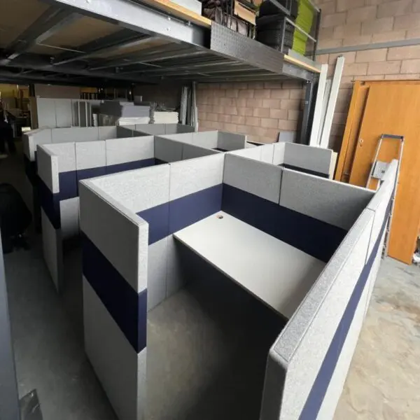 bank of 6 privacy workstation pod desks with white desk and grey upholstered screens