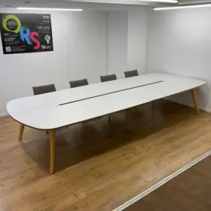 white 4200mm boardroom table with cable management gap and oak legs