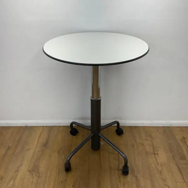 white 800mm height adjustable round table with chrome and black 4 star base on castors